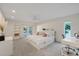 Bright main bedroom with a double bed, white decor, desk and private access to the exterior at 2969 Talon Dr, Clearwater, FL 33761