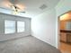 Neutral bedroom with carpet, a fan, and natural light from two windows at 31745 Blue Passing Loop, Wesley Chapel, FL 33545