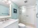 Bright bathroom features a shower and sink with lots of counter space at 3210 Gulf Blvd # 108, Belleair Beach, FL 33786