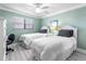 Bright and airy bedroom featuring two beds, a ceiling fan and complementary decor at 3210 Gulf Blvd # 108, Belleair Beach, FL 33786