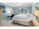 Comfortable bedroom features a ceiling fan, a workspace, and calming, pastel walls at 3210 Gulf Blvd # 108, Belleair Beach, FL 33786