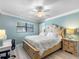 Cozy bedroom with a ceiling fan and a comfortable bed at 3210 Gulf Blvd # 108, Belleair Beach, FL 33786