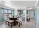 Bright dining area featuring a wooden table with seating and views of the outside at 3210 Gulf Blvd # 108, Belleair Beach, FL 33786