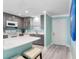 Modern kitchen featuring gray cabinets, white countertops, and stainless-steel appliances at 3210 Gulf Blvd # 108, Belleair Beach, FL 33786