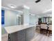 Open living space with a dining area, kitchen island, and sleek gray cabinets at 3210 Gulf Blvd # 108, Belleair Beach, FL 33786