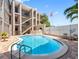 Exterior daytime shot of a beautiful condominium pool and staircases at 3210 Gulf Blvd # 108, Belleair Beach, FL 33786