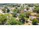 Aerial view showcases this home and the lush greenery of the surrounding neighborhood and its lake at 3225 Bea Ct, Land O Lakes, FL 34639
