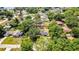 Aerial view shows this charming home featuring a pool, outdoor living area, and fenced yard at 3225 Bea Ct, Land O Lakes, FL 34639