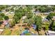 Wide aerial shot of the property, showcasing the pool, fenced yard, and mature landscaping at 3225 Bea Ct, Land O Lakes, FL 34639