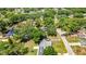 Aerial view of property with solar panels on roof and lush green landscaping at 3225 Bea Ct, Land O Lakes, FL 34639