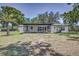 Large screened-in patio in a spacious backyard, perfect for outdoor living at 3225 Bea Ct, Land O Lakes, FL 34639