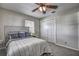 Cozy bedroom featuring ceiling fan, closet, and comfy-looking bed with stylish bedding at 3225 Bea Ct, Land O Lakes, FL 34639