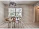 Inviting dining area featuring modern chandelier and great natural light, perfect for hosting intimate dinners at 3225 Bea Ct, Land O Lakes, FL 34639