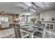 Open dining room with an elegant light fixture, set table, and view to the kitchen and living spaces at 3225 Bea Ct, Land O Lakes, FL 34639