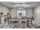 Dining room features a modern chandelier, a rustic wooden table, and a window view at 3225 Bea Ct, Land O Lakes, FL 34639
