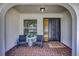 Inviting covered entryway with decorative front door and cozy seating area at 3225 Bea Ct, Land O Lakes, FL 34639
