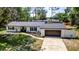 Charming single-story home featuring a neatly landscaped front yard and attached garage at 3225 Bea Ct, Land O Lakes, FL 34639