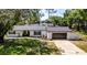Charming single-story home featuring a neatly landscaped front yard and attached garage at 3225 Bea Ct, Land O Lakes, FL 34639