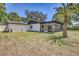 The home's exterior showcases a screened-in porch area, perfect for outdoor dining and enjoying the beautiful surroundings at 3225 Bea Ct, Land O Lakes, FL 34639