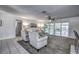 Bright and spacious living room features neutral colors and direct access to the outdoor patio at 3225 Bea Ct, Land O Lakes, FL 34639