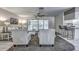 Bright living room featuring sliding glass doors, modern ceiling fan, and an open view to the kitchen at 3225 Bea Ct, Land O Lakes, FL 34639