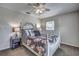 Cozy main bedroom with a ceiling fan, decorative pillows, and natural light from the window at 3225 Bea Ct, Land O Lakes, FL 34639