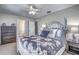 Main bedroom with a decorative bed frame, ceiling fan, and a view of the closet space at 3225 Bea Ct, Land O Lakes, FL 34639