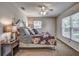 Comfortable main bedroom with a ceiling fan, stylish decor, and bright natural lighting at 3225 Bea Ct, Land O Lakes, FL 34639