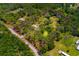 Aerial view of the property showing its boundaries, surrounded by lush greenery and scattered homes at 3226 Palmetto Rd, Wimauma, FL 33598