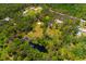 Expansive property featuring lush greenery, mature trees and a pond, enclosed by a bright pink line at 3226 Palmetto Rd, Wimauma, FL 33598
