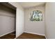 Cozy bedroom has wood flooring, an arched window, and a sliding-door closet with shelving at 3226 Palmetto Rd, Wimauma, FL 33598
