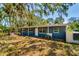 Charming single-story home featuring a front porch, mature trees, and a classic design at 3226 Palmetto Rd, Wimauma, FL 33598