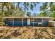 Inviting single-story home featuring a front porch, traditional windows, and a lush front yard at 3226 Palmetto Rd, Wimauma, FL 33598