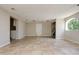 Spacious living room with neutral walls, tile flooring, and plenty of natural light, adjacent to kitchen at 3226 Palmetto Rd, Wimauma, FL 33598