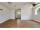 Spacious living room boasts wood floors, recessed lighting, and arched windows with a view of the surrounding trees at 3226 Palmetto Rd, Wimauma, FL 33598