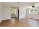 Bright living room featuring wood flooring, recessed lights, and natural light from the arched windows at 3226 Palmetto Rd, Wimauma, FL 33598