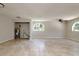Spacious living room features tile flooring, arched windows, and a ceiling fan at 3226 Palmetto Rd, Wimauma, FL 33598