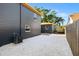 Open backyard featuring grey siding, white gravel, and tropical landscaping at 3228 7Th N Ave, St Petersburg, FL 33713