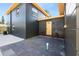 View of the backyard featuring a dark painted home with yellow door and hardscaped patio at 3228 7Th N Ave, St Petersburg, FL 33713