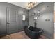 Bathroom with a freestanding black tub, gray walls, and unique oval mirrors at 3228 7Th N Ave, St Petersburg, FL 33713