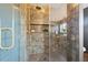 Stylish bathroom boasts a glass enclosed shower with rainfall showerhead and decorative tile at 3228 7Th N Ave, St Petersburg, FL 33713