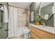 Beautiful bathroom featuring a shower-tub, wooden vanity, and artistic decor at 3228 7Th N Ave, St Petersburg, FL 33713