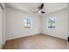 Spacious bedroom with light wood floors, bright windows, and a ceiling fan at 3228 7Th N Ave, St Petersburg, FL 33713