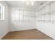 Walk-in closet with custom shelving and laminate wood flooring at 3228 7Th N Ave, St Petersburg, FL 33713