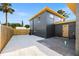 Exterior view of the dark gray house, showcasing the white gravel and the yellow door at 3228 7Th N Ave, St Petersburg, FL 33713