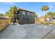 Exterior view showing the dark gray two-story home with a large concrete driveway and garage at 3228 7Th N Ave, St Petersburg, FL 33713