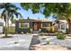 Charming home features a gray exterior, yellow shutters, and a landscaped yard at 3228 7Th N Ave, St Petersburg, FL 33713