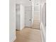 Bright hallway featuring hardwood floors, white walls, and access to a staircase at 3228 7Th N Ave, St Petersburg, FL 33713