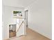 Upstairs hallway with wood floors and a window overlooking the front yard at 3228 7Th N Ave, St Petersburg, FL 33713