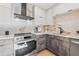 Modern kitchen features stainless steel appliances, sleek cabinetry, and stylish marble backsplash at 3228 7Th N Ave, St Petersburg, FL 33713